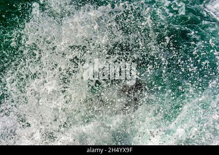 Texture of drops of sea water splashing into the air when waves crash against rocks Stock Photo