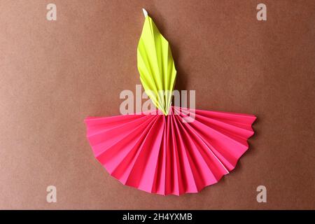 Diwali diya made with origami paper on blue background Stock Photo