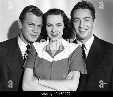 JOSEPH COTTEN TERESA WRIGHT and MACDONALD CAREY publicity portrait in SHADOW OF A DOUBT 1943 director ALFRED HITCHCOCK original story Gordon McDonell screenplay Thornton Wilder Sally Benson and Alma Reville music Dimitri Tiomkin Miss Wright's gowns by Gilbert Adrian Universal Pictures Stock Photo