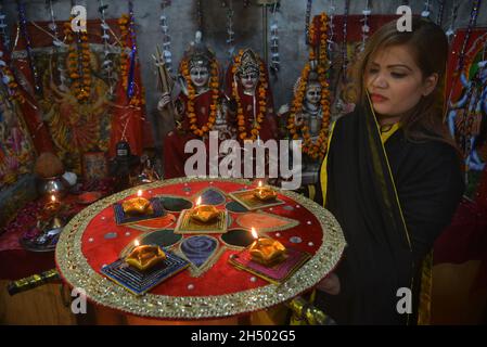 Pakistani Hindu community performing religious ritual during Diwali celebration at Shri Krishna Mandir in Lahore. Diwali (Deepavali) or Divali related to Jain Diwali, Bandi Chhor Divas, Tihar, Swanti, Sohrai and Bandna is a festival of lights and one of the major festivals celebrated by Hindus, Jains, Sikhs and some Buddhists. The festival usually lasts five days and is celebrated during the Hindu lunisolar month Kartika (between mid-October and mid-November). One of the most popular festivals of Hinduism, Diwali symbolizes the spiritual 'victory of light over darkness, good over evil, and kno Stock Photo