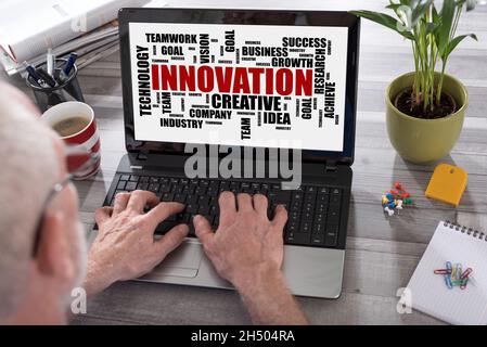 Innovation word cloud concept shown on a laptop used by a man Stock Photo