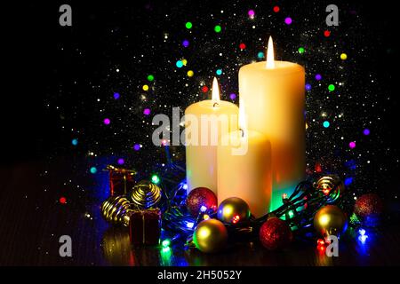 Three burning candles over a black background Stock Photo - Alamy