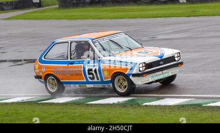 Simon Goodliff driving the Alan Mann Racing 1980 Ford Fiesta MkI during wet conditions in the Gerry Marshall Trophy. 78th Goodwood Members Meeting. Stock Photo