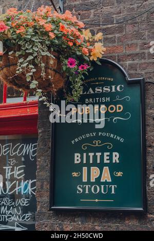 London, UK - October 17, 2021: Sign outside Anchor pub in Bankside, a historic pub on River Thames that is the sole survivor of the riverside inns tha Stock Photo