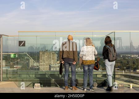 GRONINGEN, NETHERLANDS - Oct 09, 2021: People enjoying view and looking over cityscape of city from rooftop of Forum Groningen with the Martini church Stock Photo