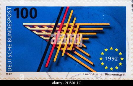 GERMANY - CIRCA 1992 : a postage stamp from Germany, showing the European emblem and five-pointed EU star, made of bars. European single market Stock Photo