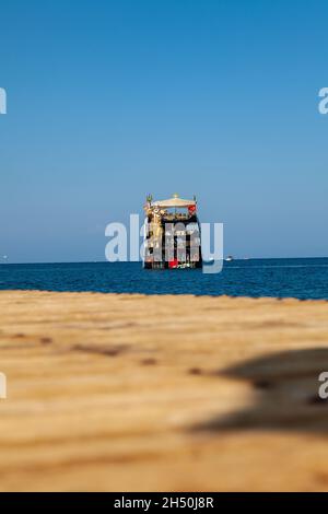 Kemer, Turkey - 08. 25. 2021: Big cruise ship Mega Star with tourists sailing in the sea in the hot summer day. Tourism and travel. Stock Photo