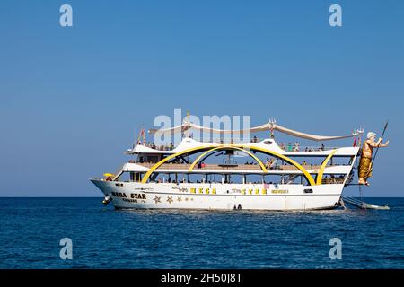 Kemer, Turkey - 08. 25. 2021: Big cruise ship Mega Star with tourists sailing in the sea in the hot summer day. Tourism and travel. Stock Photo