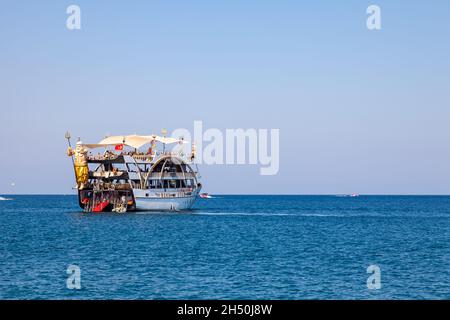 Kemer, Turkey - 08. 25. 2021: Big cruise ship Mega Star with tourists sailing in the sea in the hot summer day. Tourism and travel. Stock Photo