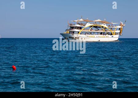 Kemer, Turkey - 08. 25. 2021: Big cruise ship Mega Star with tourists sailing in the sea in the hot summer day. Tourism and travel. Stock Photo