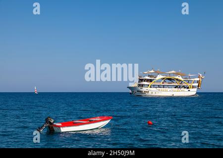 Kemer, Turkey - 08. 25. 2021: Big cruise ship Mega Star with tourists sailing in the sea in the hot summer day. Tourism and travel. Stock Photo