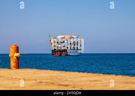 Kemer, Turkey - 08. 25. 2021: Big cruise ship Mega Star with tourists sailing in the sea in the hot summer day. Tourism and travel. Stock Photo