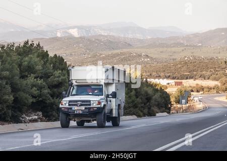 Kemer, Turkey - 08. 25. 2021: Offroad truck Toyota Land Cruiser 70 with a tent on the roof in the campsite. Stock Photo