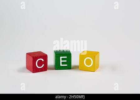 colored blocks against an isolated white background contain the letters CEO, which stand for Chief Executive Officer. Free space is available in this Stock Photo