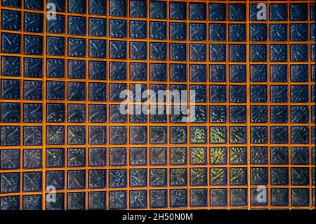 A wall of glass blocks which is lit from behind Stock Photo