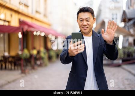 Business man having video call on hone outdoors Stock Photo
