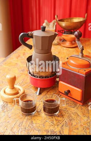 Two cups of fresh brewed espresso with retro coffee maker set on a table Stock Photo