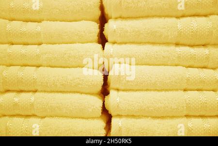 Front View of Pastel Butter Yellow Fluffy Towels Stack Stock Photo