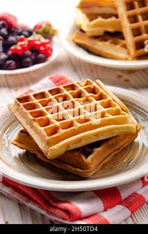 Belgian waffles served with butter banana mint leaf and syrup Stock Photo