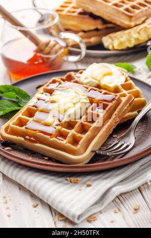 Belgian waffles served with butter and honey Stock Photo