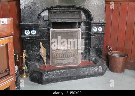 A Traditional Open Coal Fireplace with a Fire Guard. Stock Photo