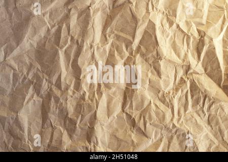 Crumpled craft paper. Background from brown wrapping paper. Stock Photo