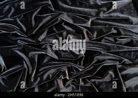 Black velvet background. Crumpled velvet. Velvet with pleats. Stock Photo