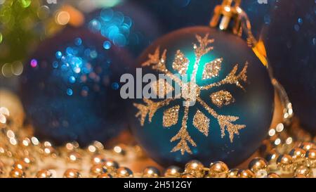 Close-up of beautiful Christmas toys with beads and garland. Concept. Christmas composition with shiny balls for Christmas tree and beads on backgroun Stock Photo