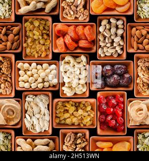 Seamless flat lay food background of dehydrated fruits, seeds and nuts on black. Non-perishable antioxidant gluten free foods concept Stock Photo