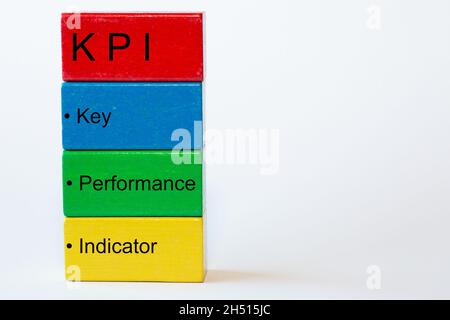 colorful blocks with the words key, performance, indicator and on top a red block with the letters KPI. The background is isolated in white Stock Photo