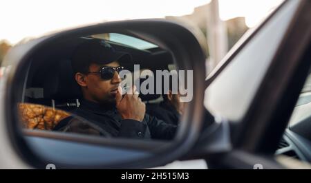Male police officer talking on a walkie-talkie Stock Photo