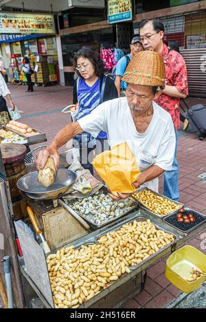 Hong Kong China,HK,Chinese,Kowloon,Prince Edward,Nathan Road,sidewalk street,vendor,Asian man male snacks snack food peanuts bird eggs Stock Photo