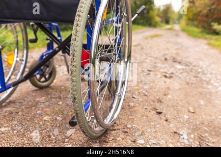 Empty wheelchair standing on road waiting for patient services. Wheel ...