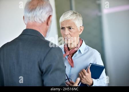 senior busniess people talking office angry argument Stock Photo
