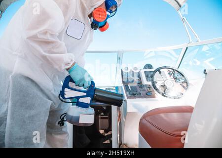 a man in a uniform disinfects the room. Stock Photo