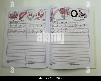 BANGALORE, INDIA - Aug 31, 2021: A close-up of an English cursive writing book with open pages isolated on white background Stock Photo