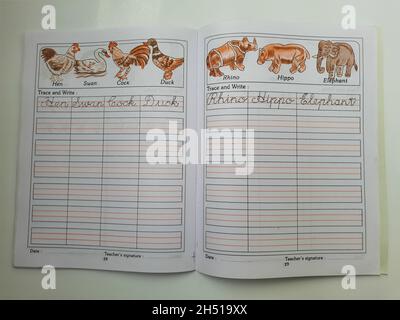 BANGALORE, INDIA - Aug 31, 2021: A close-up of an English cursive writing book with open pages isolated on white background Stock Photo