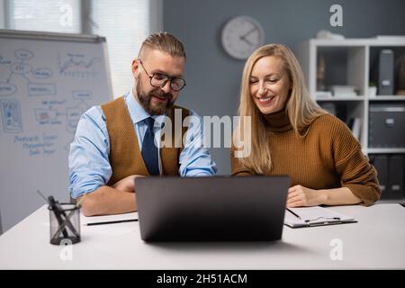 Office workers using laptop Stock Photo