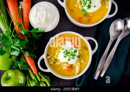 Bowls of Chicken Mulligatawny Soup: Indian curried chicken soup with vegetables and apples Stock Photo