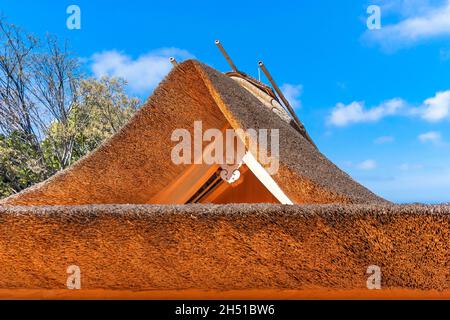 Close-up on the roof of a Japanese Tea House made in a traditional roofing method of thatching named Kayabuki thatched roof using densely packed bulk Stock Photo