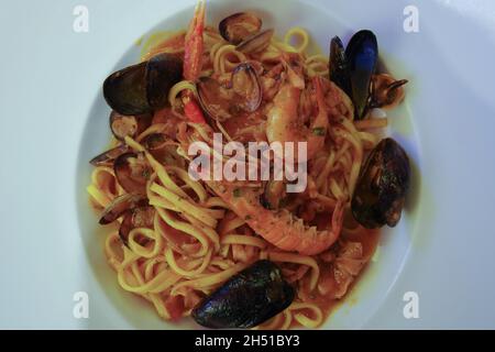 'Spaghetti allo scoglio' with different types of shellfish, mussels and clams, a typical Italian dish with seafood Stock Photo