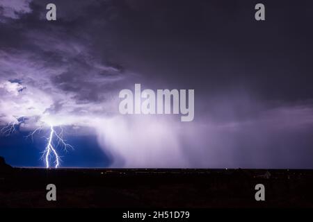 A bright lightning bolt over the city from a thunderstorm in Santa Fe, New Mexico Stock Photo