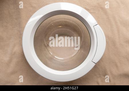 Loose unattached washing machine door frame and glass with handle from the front Stock Photo