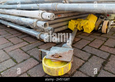Pile of components of hired scaffolding or mobile platform work tower including adjustable leg and castor Stock Photo