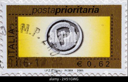 ITALY- CIRCA 2005: a postage stamp for priority delivery printed in the Italy showing the letter P on a yellow background. Text: Rome 2005 Stock Photo