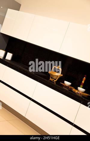 Interior of luxurious modern kitchen, white cabinets and black granite Stock Photo