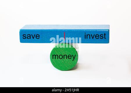 colored fragments in fragile balance to underline the choice with the words: save | money | invest Stock Photo