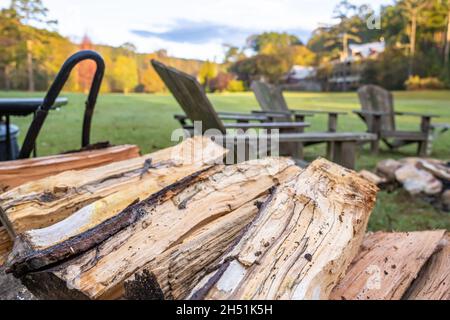 Firewood near a fire pit with a circle of Adirondack chairs at the beautiful and historic Glen-Ella Springs Inn & Restaurant in Clarkesville, Georgia. Stock Photo