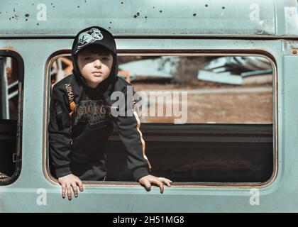 child in the window of an old train Stock Photo