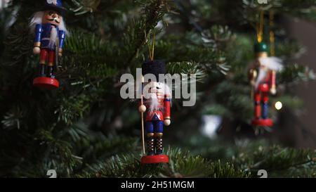 Decoration Toy Nutcracker on Christmas Tree. Nutcracker Soldier on a Christmas Tree With Blurred Background. Beautiful Decorated Christmas Tree, the N Stock Photo